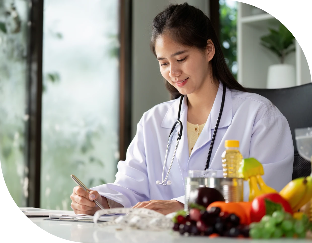 Medical professional with stethoscope and fruits